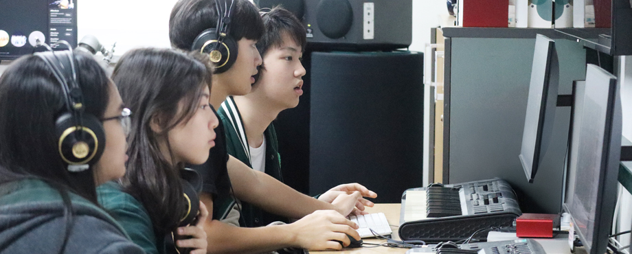 Students learning music production in APIS professional recording studio